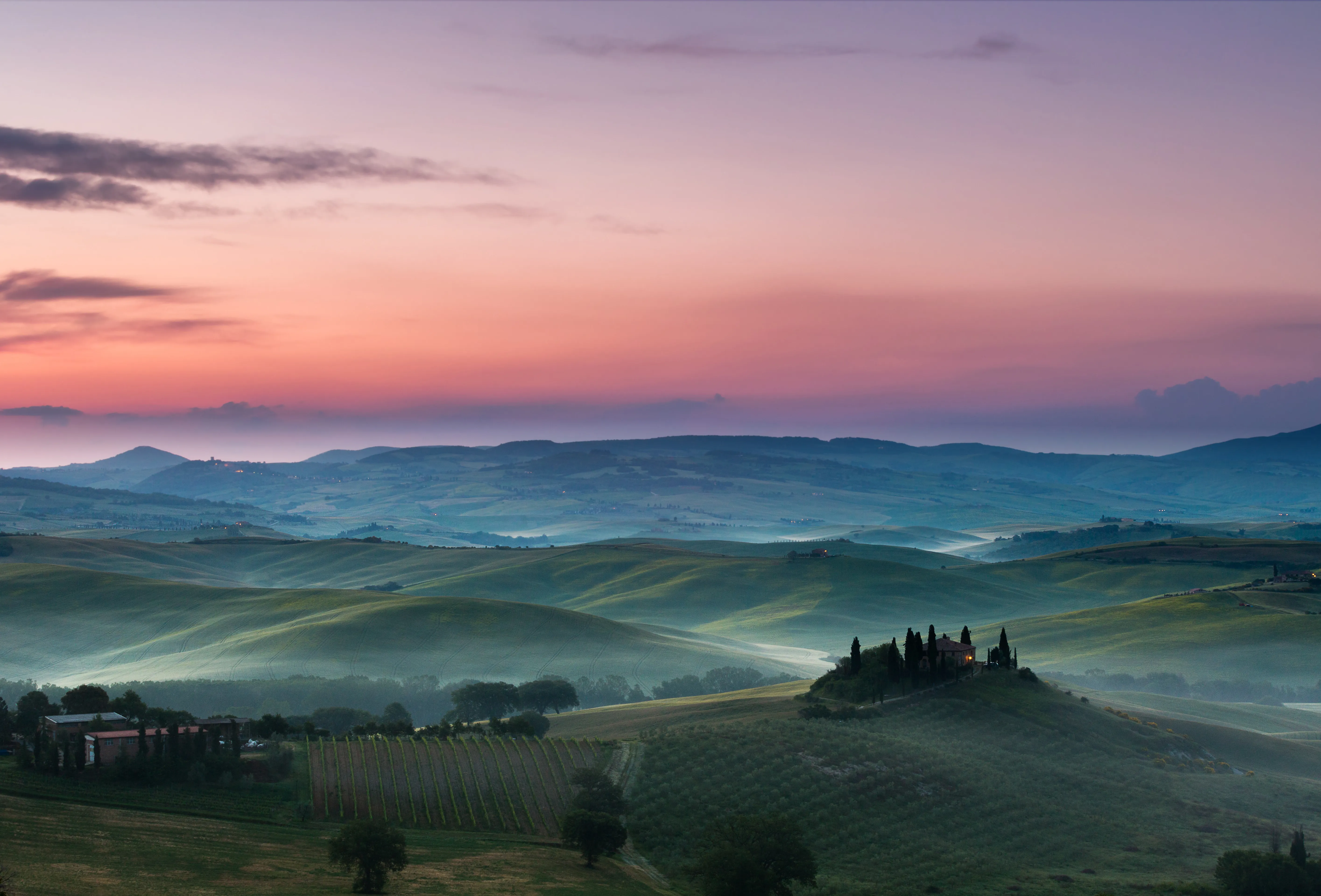 Soft pink dawn over the Tuscan hills